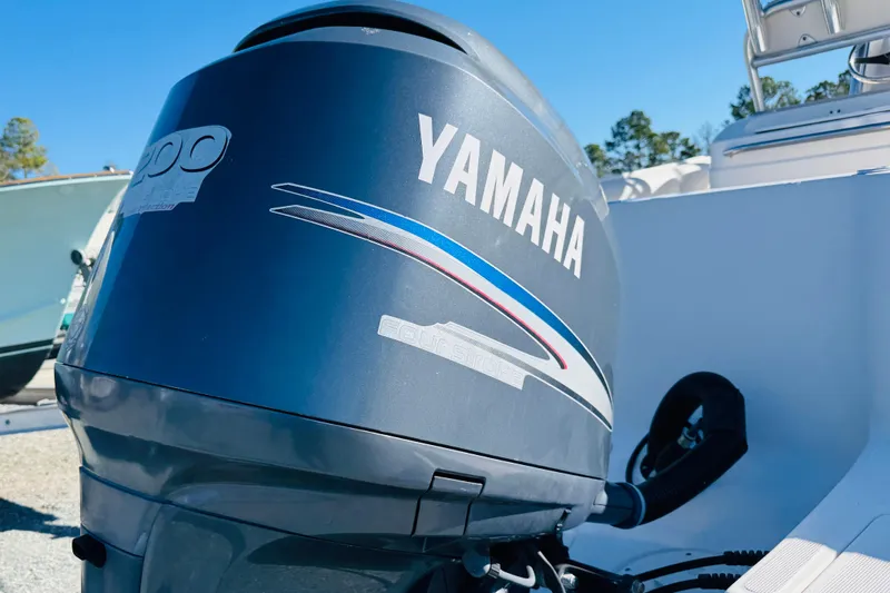 Slide: The Image of 2005 Robalo R220 Center Console with Yamaha outboard motor in sunny setting. - 3