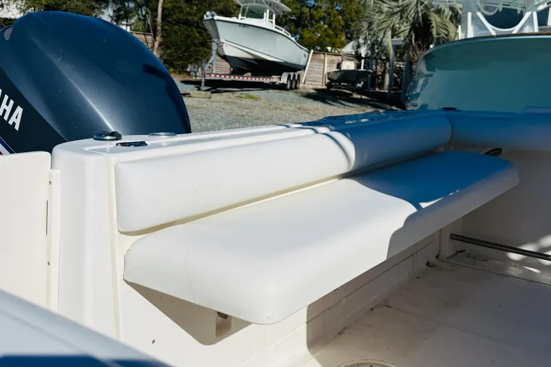 Slide: The Image of 2005 Robalo R220 Center Console boat with Yamaha engine, featuring white seating. - 4