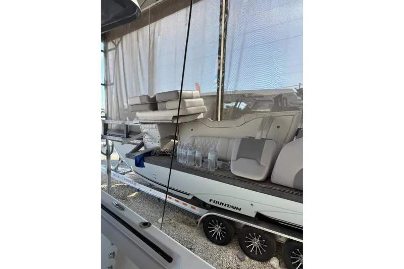 Slide: The Image of 2021 Mako 234 Center Console boat on trailer, covered and stored outdoors. - 11