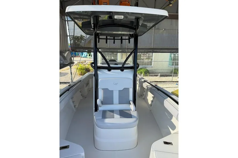 Slide: The Image of 2021 Mako 234 Center Console boat interior with seating and canopy. - 6