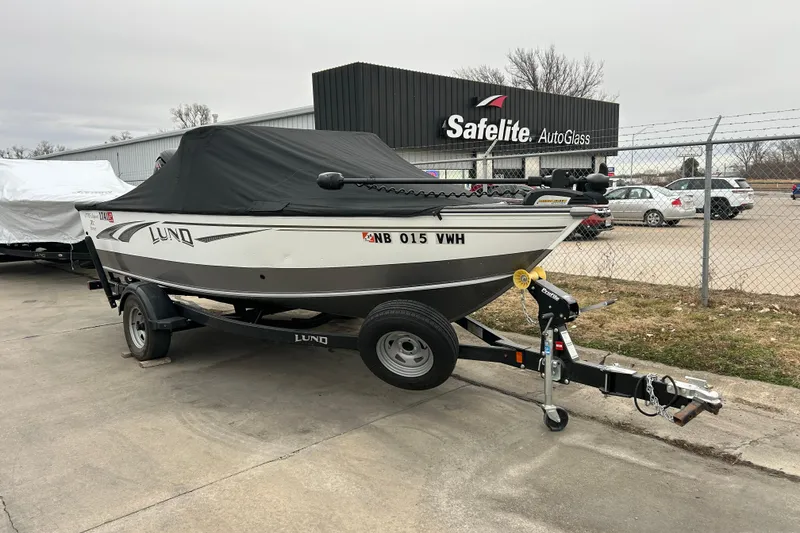 Slide: The Image of 2018 Lund 1775 Impact Sport boat on trailer, parked near Safelite AutoGlass. - 10