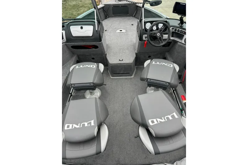 Slide: The Image of 2018 Lund 1775 Impact Sport boat interior with gray seating and steering console. - 14