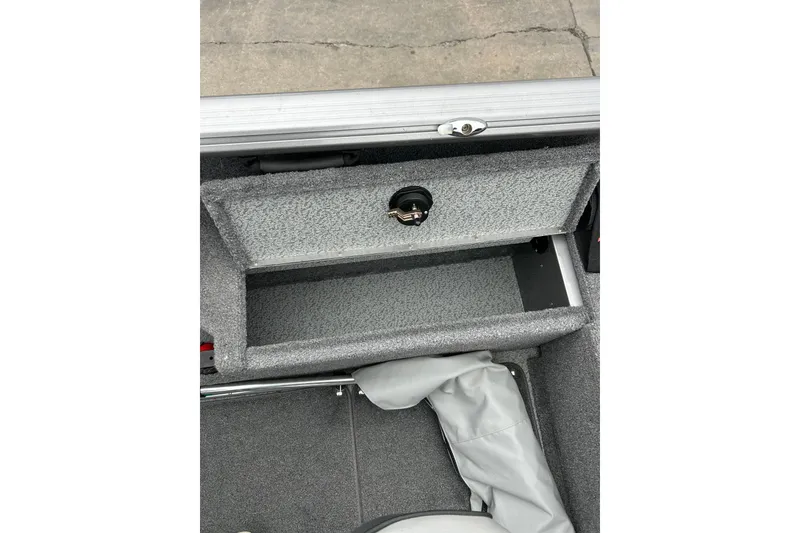 Slide: The Image of 2018 Lund 1775 Impact Sport boat storage compartment with gray interior. - 16