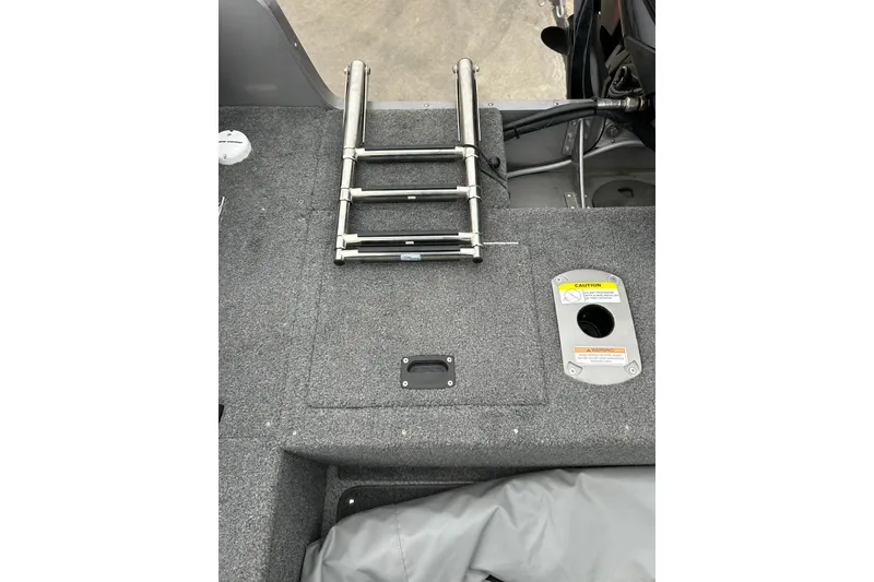 Slide: The Image of 2018 Lund 1775 Impact Sport boat interior with ladder and storage compartment. - 19