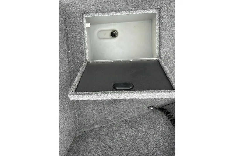 Slide: The Image of 2018 Lund 1775 Impact Sport boat storage compartment, open with gray interior. - 20