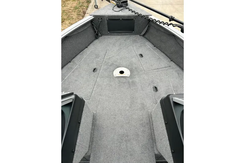 Slide: The Image of 2018 Lund 1775 Impact Sport boat interior with gray carpeted deck. - 22