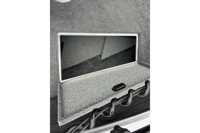 Slide: The Image of 2018 Lund 1775 Impact Sport boat storage compartment with carpeted interior. - 26