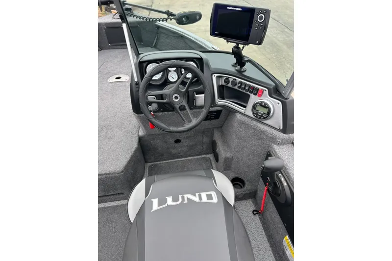 Slide: The Image of 2018 Lund 1775 Impact Sport boat interior with steering wheel and control panel. - 28