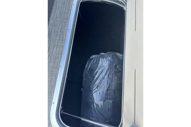 Slide: The Image of Storage compartment of 2026 Bennington S Swingback 23 SSB ESP boat, containing a wrapped item. - 12