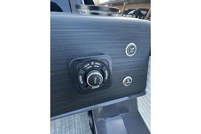 Slide: The Image of Control panel of 2026 Bennington S Swingback 23 SSB ESP boat with lighting and horn buttons. - 23