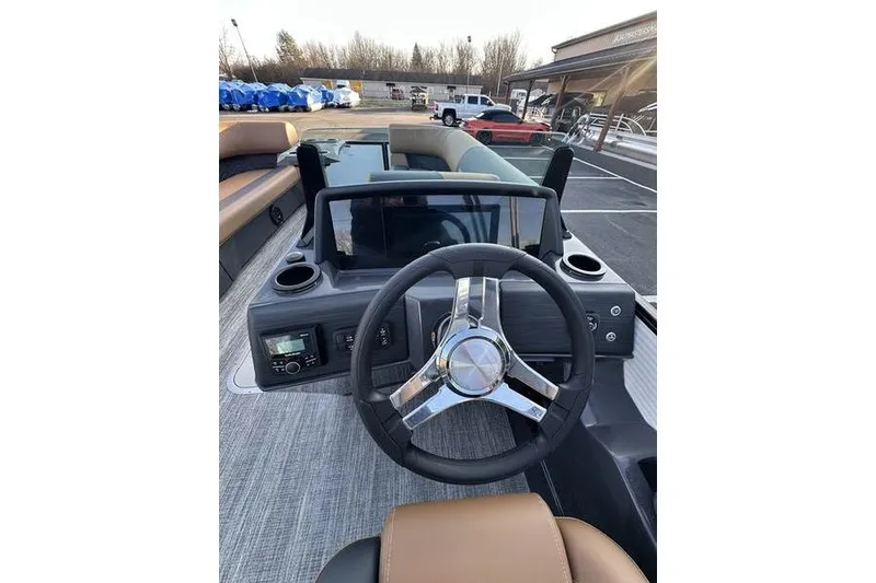 Slide: The Image of 2026 Bennington S Swingback 23 SSB ESP boat dashboard with steering wheel and controls. - 24