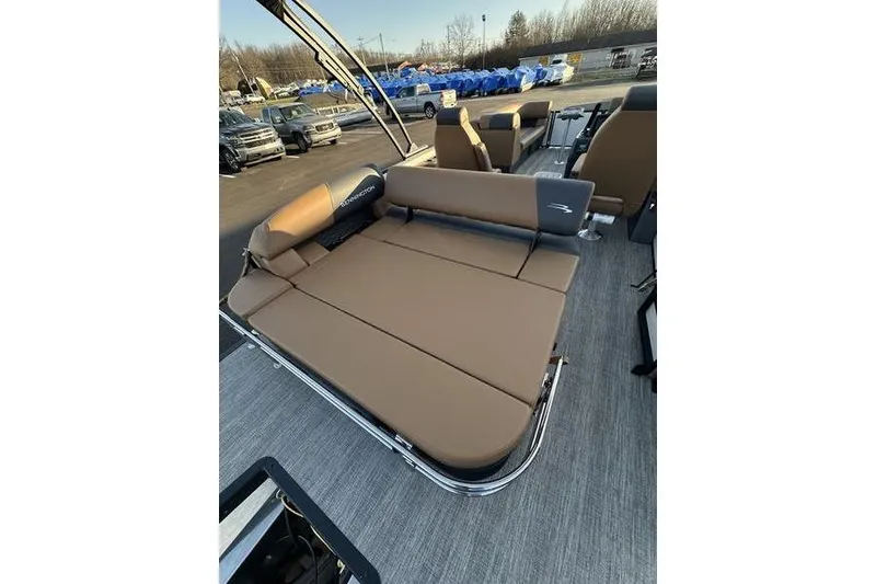 Slide: The Image of 2026 Bennington S Swingback 23 SSB ESP pontoon boat with tan seating and spacious layout. - 25