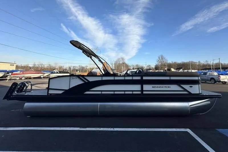 Slide: The Image of 2026 Bennington S Swingback 23 SSB ESP pontoon boat in parking lot, clear sky background. - 7