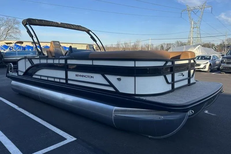 Slide: The Image of 2026 Bennington S Swingback 23 SSB ESP pontoon boat in a parking lot. - 9