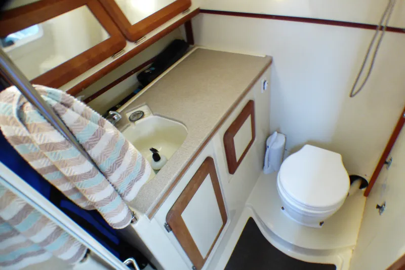 Slide: The Image of Compact bathroom in 1994 Hunter Legend 35.5 sailboat with sink, toilet, and storage. - 10
