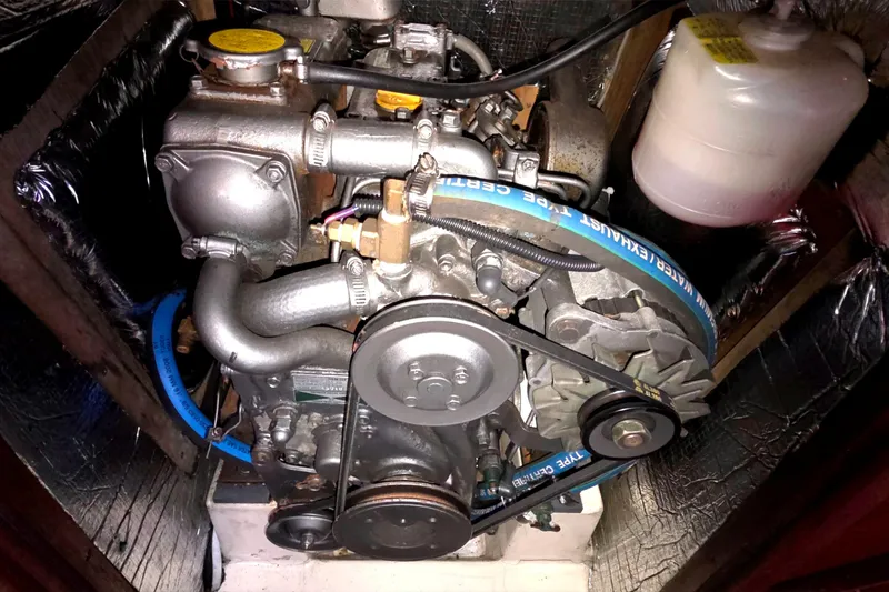 Slide: The Image of Engine of a 1994 Hunter Legend 35.5 sailboat, showcasing belts and components. - 21