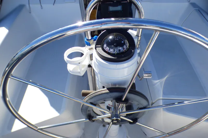 Slide: The Image of Steering wheel and compass of 1994 Hunter Legend 35.5 sailboat cockpit. - 22