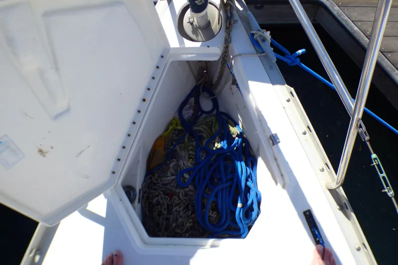 Slide: The Image of Open anchor locker on 1994 Hunter Legend 35.5 sailboat with ropes and chains. - 25
