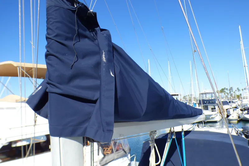 Slide: The Image of 1994 Hunter Legend 35.5 sailboat with blue sail cover in marina. - 26