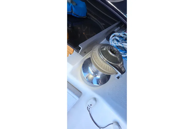 Slide: The Image of Winch on 1994 Hunter Legend 35.5 sailboat deck with coiled rope. - 33
