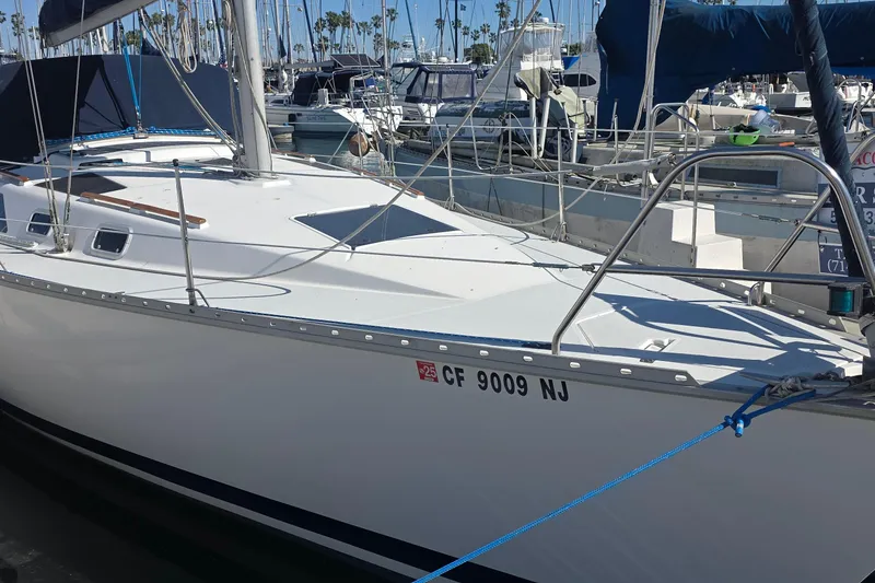 Slide: The Image of 1994 Hunter Legend 35.5 sailboat docked in marina, surrounded by other boats. - 4