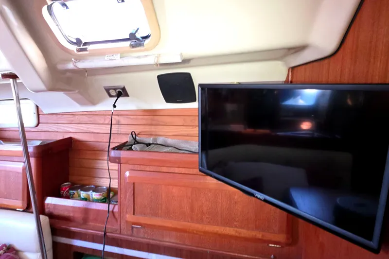 Slide: The Image of Interior of 1994 Hunter Legend 35.5 yacht with TV and wooden cabinetry. - 8