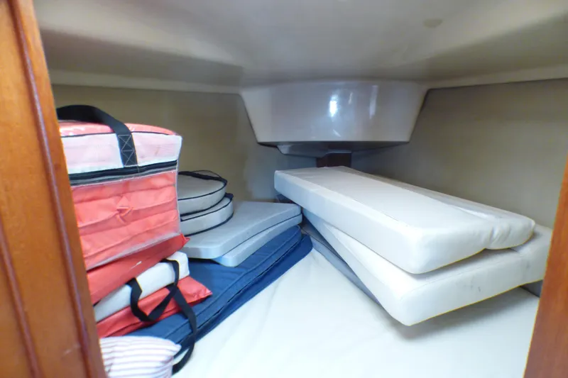 Slide: The Image of Interior cabin storage of 1994 Hunter Legend 35.5 sailboat with cushions and bags. - 9
