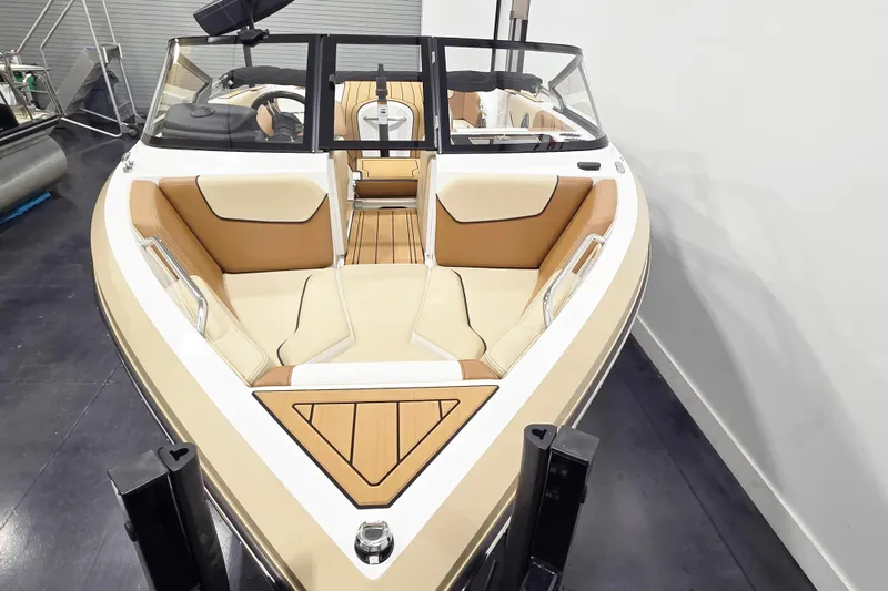 Slide: The Image of 2025 Nautique Ski Nautique boat interior with tan and cream seating, sleek design. - 4