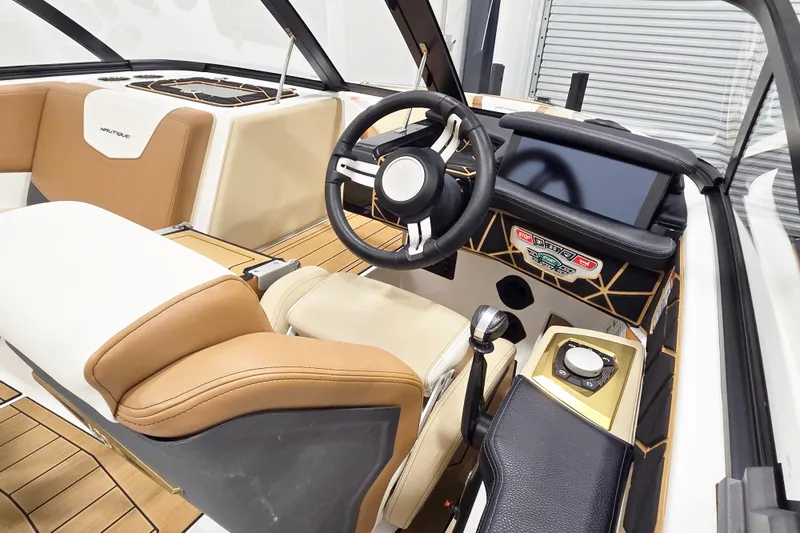 Slide: The Image of 2025 Nautique Ski Nautique boat interior with modern dashboard and steering wheel. - 5
