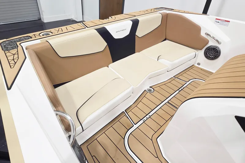 Slide: The Image of 2025 Nautique Ski Nautique interior with tan and cream seating, teak flooring. - 8