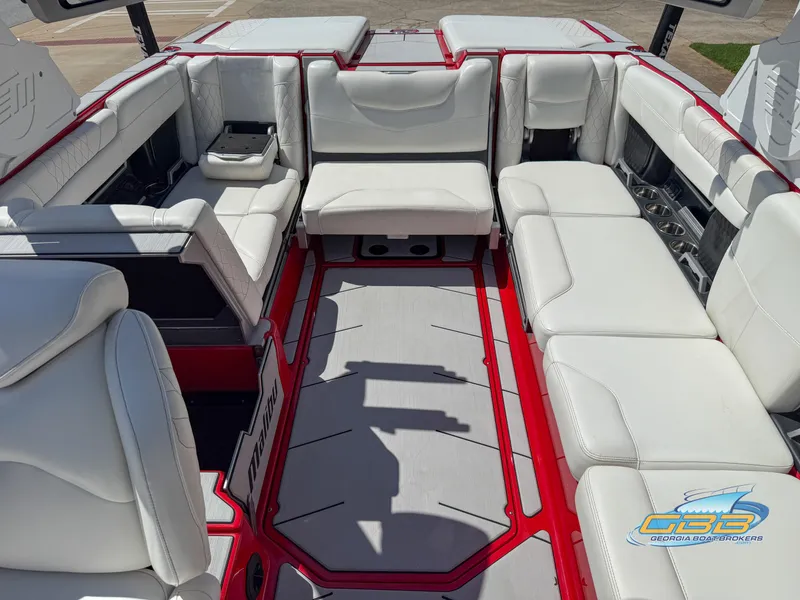 Slide: The Image of Interior of 2021 Malibu M240 boat with white seating and red accents. - 32