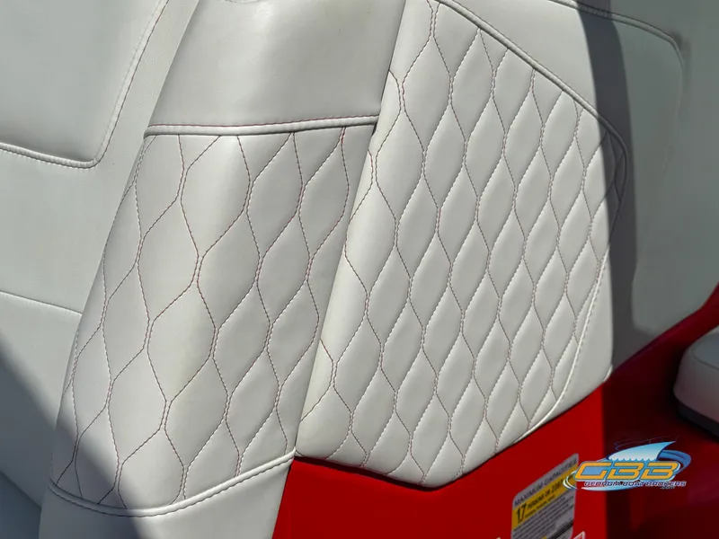Slide: The Image of 2021 Malibu M240 boat seat with diamond-stitched white leather upholstery and red accents. - 34