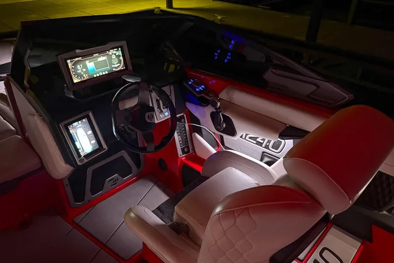 Slide: The Image of 2021 Malibu M240 boat interior with illuminated dashboard and modern controls. - 4