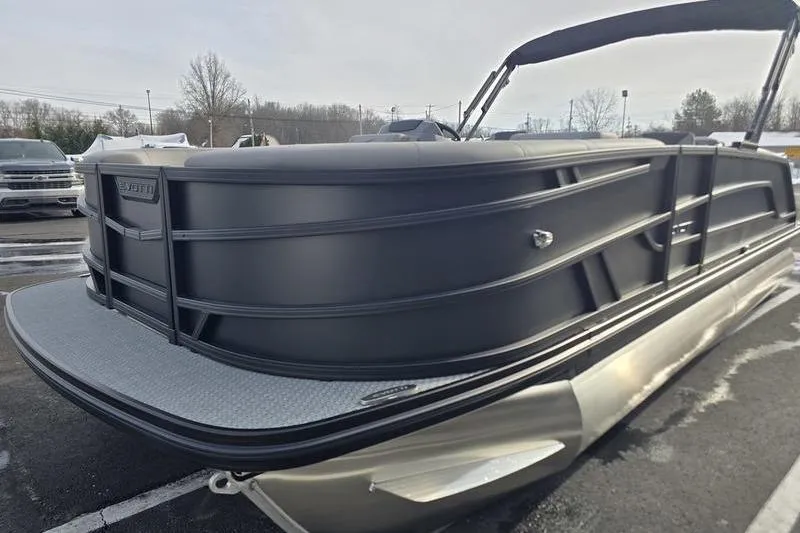 Slide: The Image of 2026 Evotti 521QL pontoon boat with sleek black design in a parking lot. - 4
