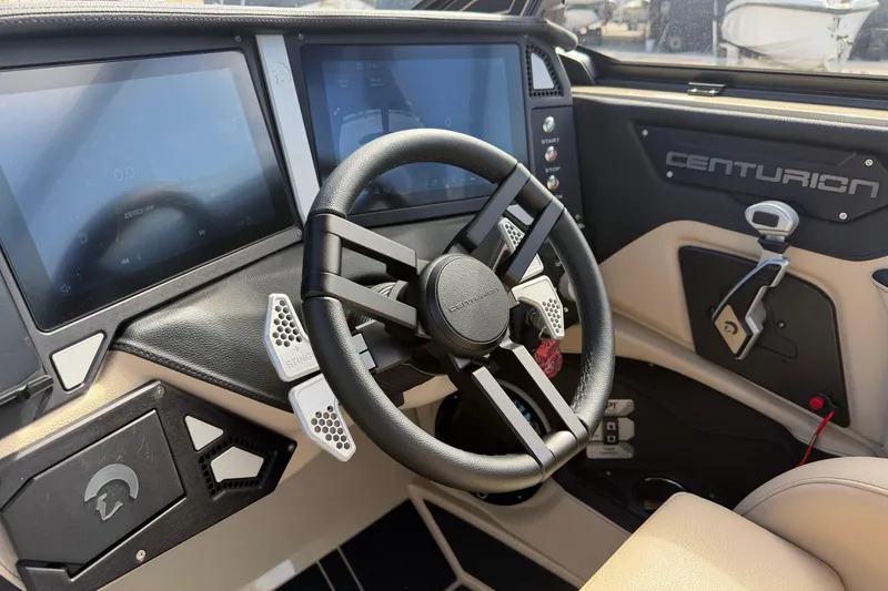 Slide: The Image of 2026 Centurion Ri230 boat dashboard with steering wheel and digital displays. - 14