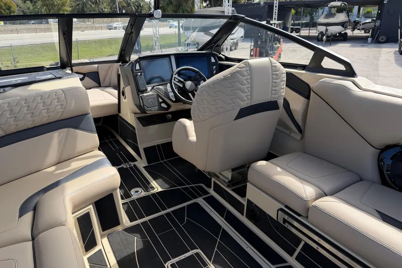 Slide: The Image of Luxurious interior of 2026 Centurion Ri230 boat with plush seating and modern dashboard. - 18