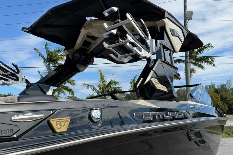 Slide: The Image of 2026 Centurion Ri230 boat with sleek design and advanced features, parked outdoors. - 5