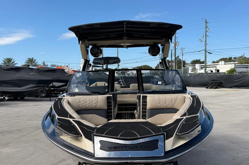 Slide: The Image of 2026 Centurion Ri230 boat with sleek design and luxurious seating, displayed outdoors. - 7