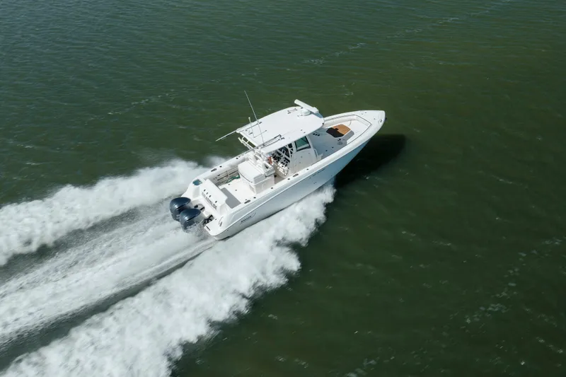 Slide: The Image of 2013 Boston Whaler 320 Outrage speeding on open water, aerial view. - 12
