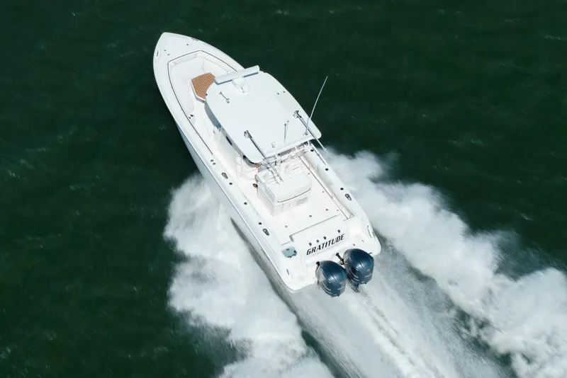 Slide: The Image of 2013 Boston Whaler 320 Outrage speeding on open water, aerial view. - 13