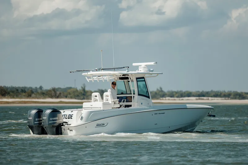 Slide: The Image of 2013 Boston Whaler 320 Outrage boat cruising on open water with dual Yamaha engines. - 22