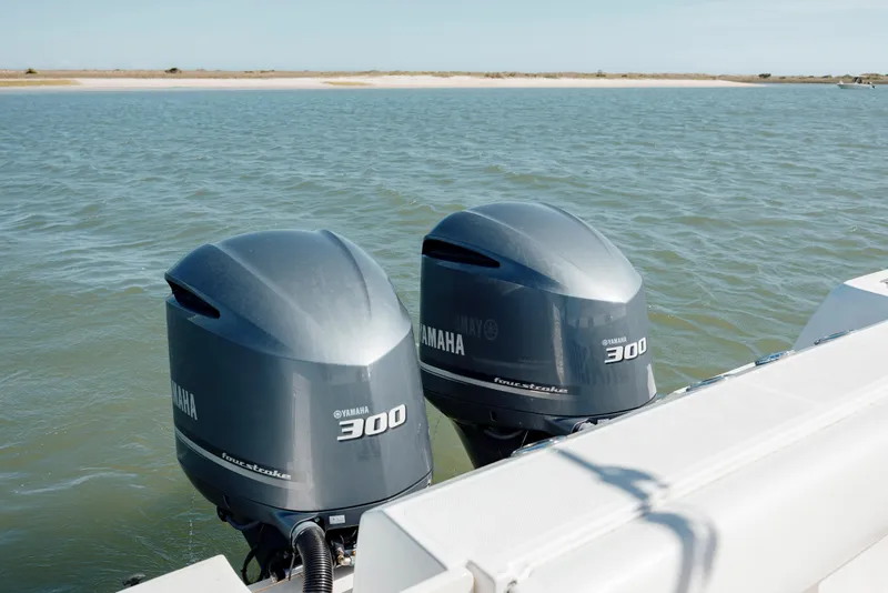 Slide: The Image of Twin Yamaha 300 engines on a 2013 Boston Whaler 320 Outrage in open water. - 23