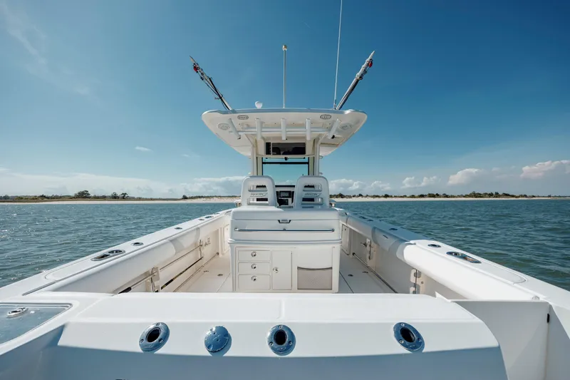 Slide: The Image of 2013 Boston Whaler 320 Outrage boat on calm water under clear blue sky. - 25