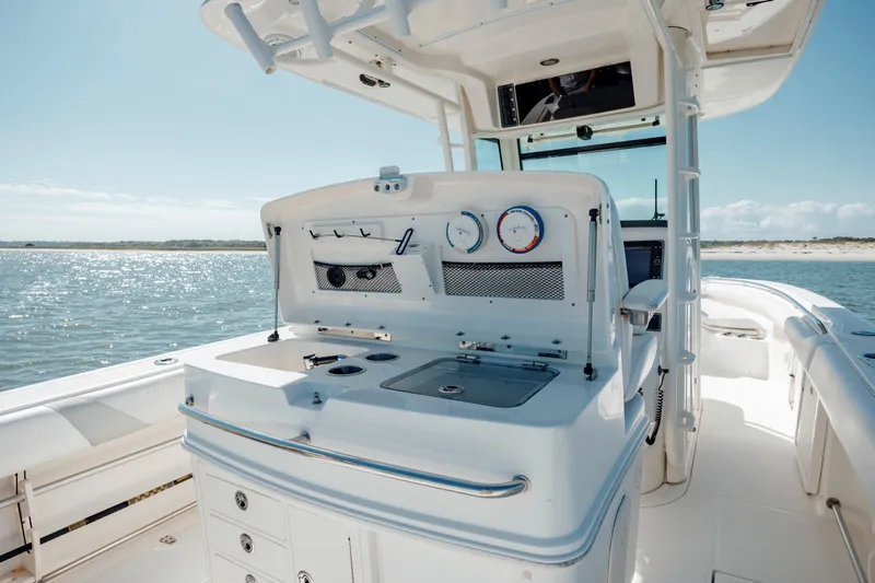 Slide: The Image of 2013 Boston Whaler 320 Outrage boat interior with fishing station and ocean view. - 29