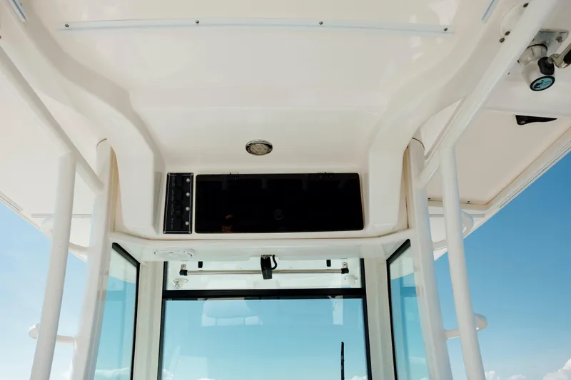 Slide: The Image of Interior view of a 2013 Boston Whaler 320 Outrage boat, showcasing the helm area. - 35