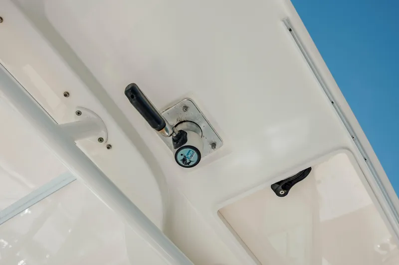 Slide: The Image of 2013 Boston Whaler 320 Outrage boat detail with handle and latch against blue sky. - 36