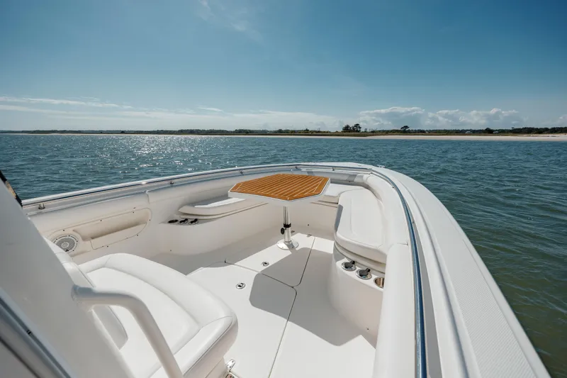 Slide: The Image of 2013 Boston Whaler 320 Outrage boat interior with ocean view and seating area. - 39