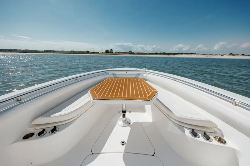 Slide: The Image of 2013 Boston Whaler 320 Outrage boat with wooden table, cruising on calm waters. - 40