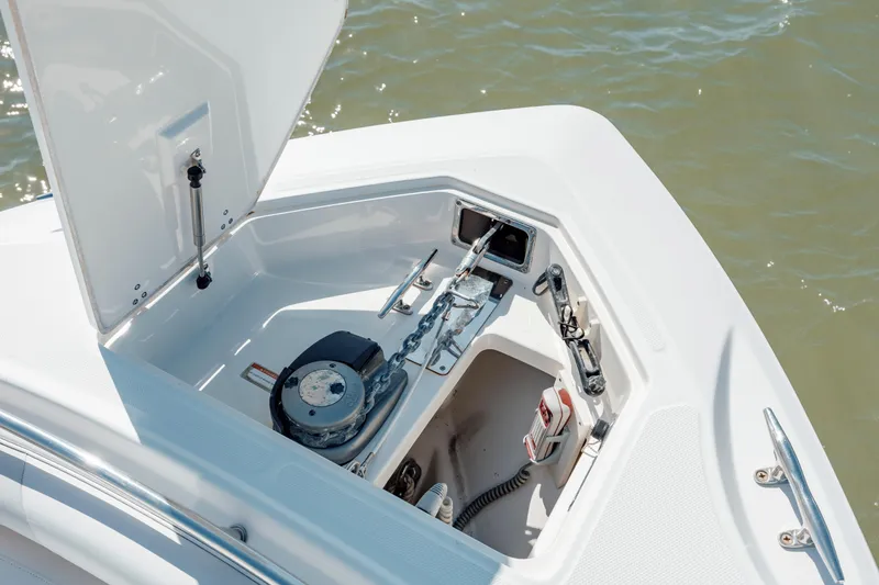Slide: The Image of 2013 Boston Whaler 320 Outrage anchor compartment with open hatch, showcasing anchor and chain. - 41
