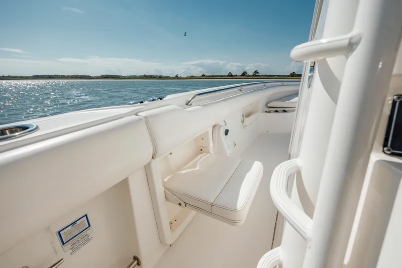 Slide: The Image of 2013 Boston Whaler 320 Outrage boat interior with white seating, on a sunny day. - 44